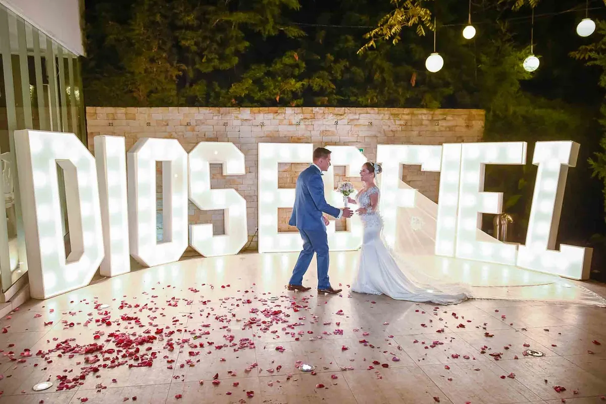 Novia con un velo largo junto a su pareja en la recepción de la boda